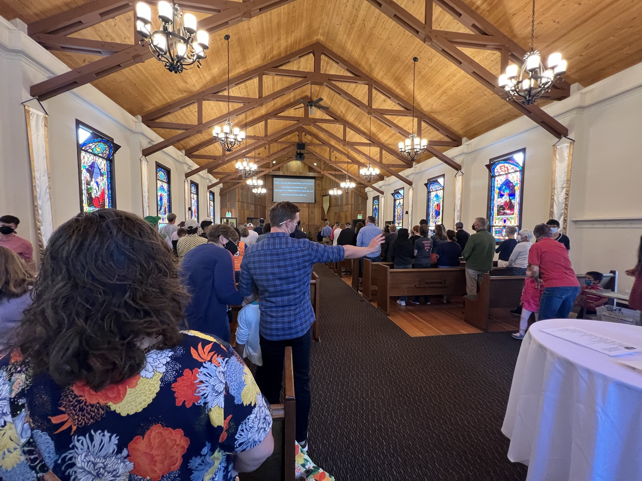 Sanctuary full of worshippers standing and singing